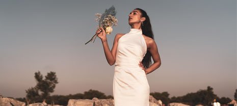 bride-with-bridal-bouquet-standing-on-rocks-2022-01-18-23-51-51-utc